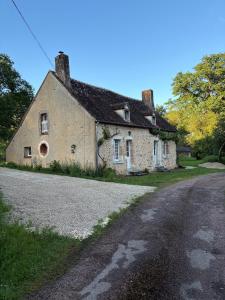 an old stone house on the side of a road at Gîte Les Moreaux in Saint-Amand-en-Puisaye