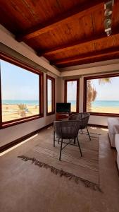 a living room with a view of the beach at Matarma Bay Hotel in Ras Sedr +21 photos