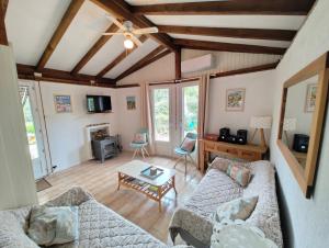 a living room with two couches and a table at Les 4 mousquetaires in Méjannes-le-Clap