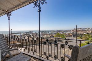 a balcony with chairs and a view of the ocean at The House at Ramsgate in Ramsgate