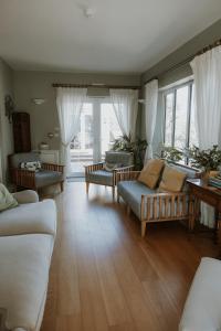 a living room with couches and a large window at Florence House Bed & Breakfast in Seaford