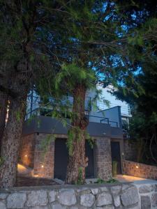a house with two trees in front of it at 20 Koraka in Klenovica