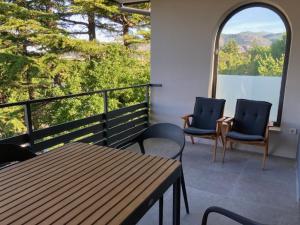 two chairs and a table on a balcony at 20 Koraka in Klenovica +3 photos