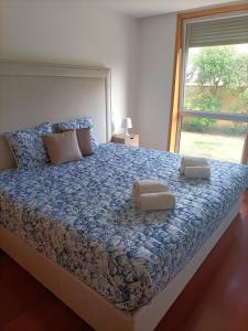 a bedroom with a large bed with two pillows on it at Pacos Beach House in Lavra