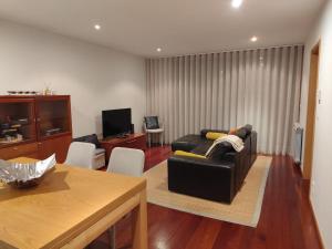 a living room with a couch and a table at Pacos Beach House in Lavra