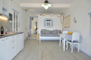 a kitchen and living room with a table and a couch at Seafis Boathouse Klima in Klima +39 photos