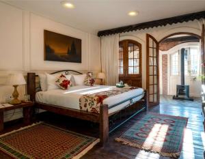 a bedroom with a large bed in a room at Hazaar Dastaan Kashmir in Srinagar +20 photos