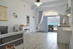 a kitchen and living room with a view of the ocean at Seafis Boathouse Klima in Klima