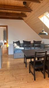 a living room with a couch and a table and chairs at Penzion Za plotem in Vranová