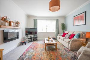 a living room with a couch and a coffee table at Boyd’s Bungalow, Lowestoft in Lowestoft