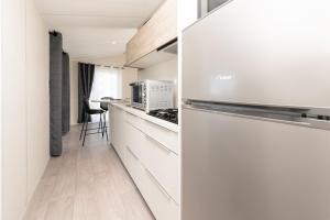 a kitchen with white cabinets and a refrigerator at La Brisse d'Erdeven in Erdeven +14 photos