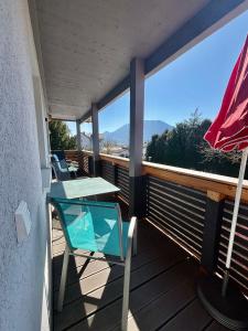 a patio with a table and chairs on a balcony at Uii Apartments Oberaudorf in Oberaudorf