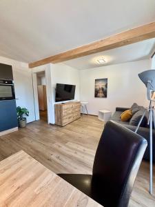 a living room with a couch and a flat screen tv at Uii Apartments Oberaudorf in Oberaudorf