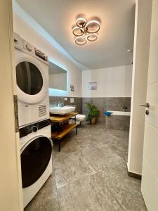 a bathroom with a sink and a microwave at Uii Apartments Oberaudorf in Oberaudorf +34 photos