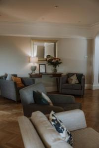 a living room with two couches and a mirror at Florence House Bed & Breakfast in Seaford
