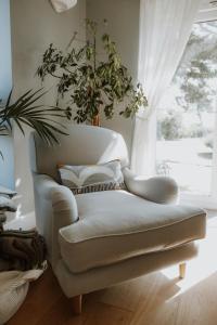 a couch in a living room with a window at Florence House Bed & Breakfast in Seaford