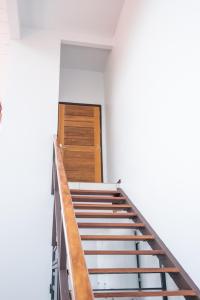 a staircase leading to a door in a room at Bantaskine Apartments in Paramaribo +13 photos