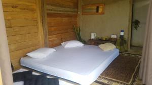 a large white bed in a room at Le Pandai in Bogor