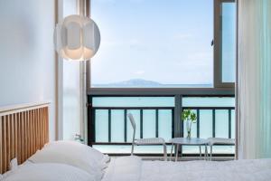 a bedroom with a bed and a table and a window at Wando Love You Pension in Wando +8 photos