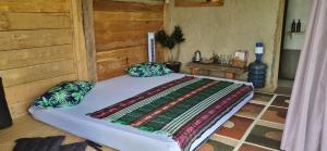 a bedroom with a bed with a quilt on it at Le Pandai in Bogor
