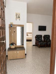 a living room with a television and a couch at La maison douce Bizerte in Bizerte