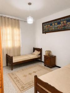 a living room with two beds and a table at La maison douce Bizerte in Bizerte