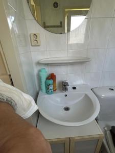 a white bathroom with a sink and a mirror at De huismus in Sleen +25 photos