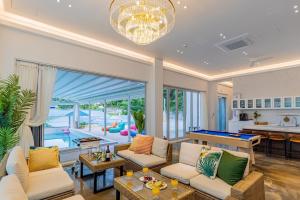 a living room with couches and a pool table at Private Yangyang Dockchae Pool Villa in Yangyang