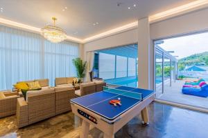 a living room with a ping pong table in it at Private Yangyang Dockchae Pool Villa in Yangyang +13 photos