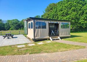 a small tent with a picnic table and a bench at Hampshire Hills in Bighton