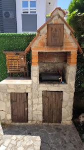 a stone oven with two doors and a pipe in it at The House Apartments & Guest Rooms in Ohrid
