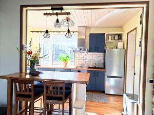 a kitchen with a wooden table and a refrigerator at Meie Hiiumaa majutus Kärdlas in Kärdla +6 photos
