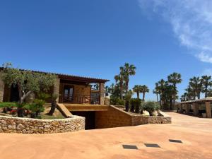 a house with a stone walkway in front of it at Villa Demetra Resort in San Leone