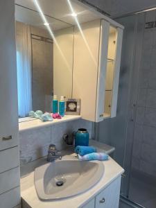 a bathroom with a sink and a mirror at Eden apartments 2 in Bardolino +25 photos