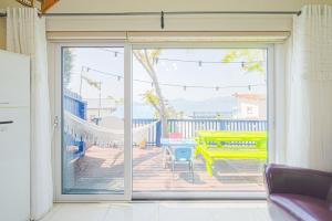 a sliding glass door with a view of a patio at Namhae arahil pension in Namhae