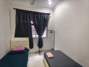 a bedroom with a bed and a window at AA Homestay Bandar Mahkota Banting in Banting
