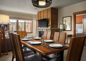 a dining room with a wooden table and chairs at The Residences at Main Street Station by Hyatt Vacation Club in Breckenridge