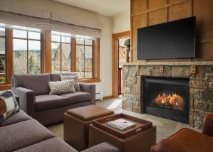a living room with a fireplace with a flat screen tv at The Residences at Main Street Station by Hyatt Vacation Club in Breckenridge