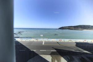 a view of the beach and the ocean from a building at Hamduk Pungkyungchae Pension in Jeju