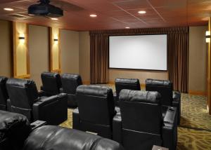 a conference room with leather chairs and a white screen at The Residences at Main Street Station by Hyatt Vacation Club in Breckenridge +36 photos