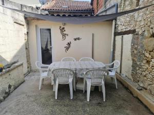 a white table and chairs on a patio at Cottage Sleeps 2- Pet Friendly WiFi Free Parking in Montauriol +10 photos