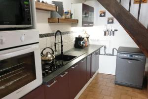 a kitchen with a sink and a stove top oven at Cottage Sleeps 2- Pet Friendly WiFi Free Parking in Montauriol