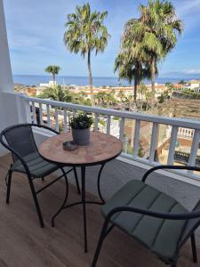 a table and chairs on a balcony with the beach at Cozy Studio Sea View in Chayofa in Chayofa