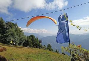 a kite and a flag on top of a hill at Urbane Haauz in Pelling