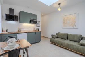 a living room with a couch and a table at Le Clos de Vaires in Vaires-sur-Marne +13 photos