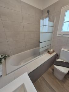 a bathroom with a white tub and a toilet at Cozy Studio Sea View in Chayofa in Chayofa +16 photos