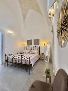 a bedroom with a bed in a white room at Amare Gallipoli in Gallipoli +111 photos