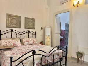a bedroom with a bed and a door to a balcony at Amare Gallipoli in Gallipoli