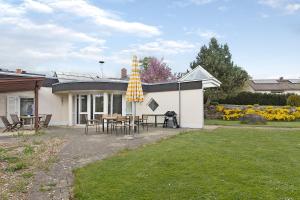 a house with a patio with a table and chairs at Hygge Home Schwarzwald in Villingen-Schwenningen