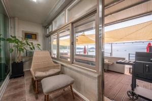 a room with a chair and a table with an umbrella at Wando Love You Pension in Wando